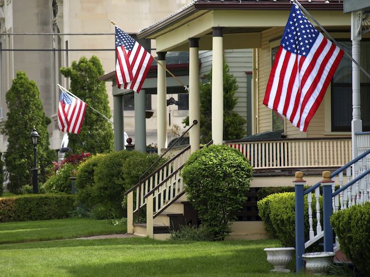 Agent next to sold sign